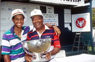 Tiger and Earl Woods hold a trophy