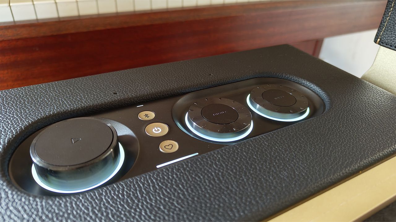 A close-up of the top of a black JBL Authentics 300 wireless speaker showing the controls and buttons.