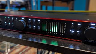 A Focusrite Scarlett 18i20 4th Gen on a table in a recording studio