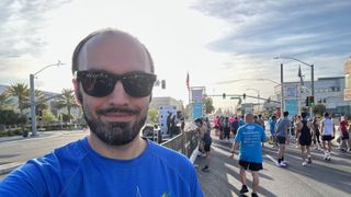 The author wearing Meta Ray-Ban smart glasses in a selfie with the start line of the San Jose half marathon behind him.