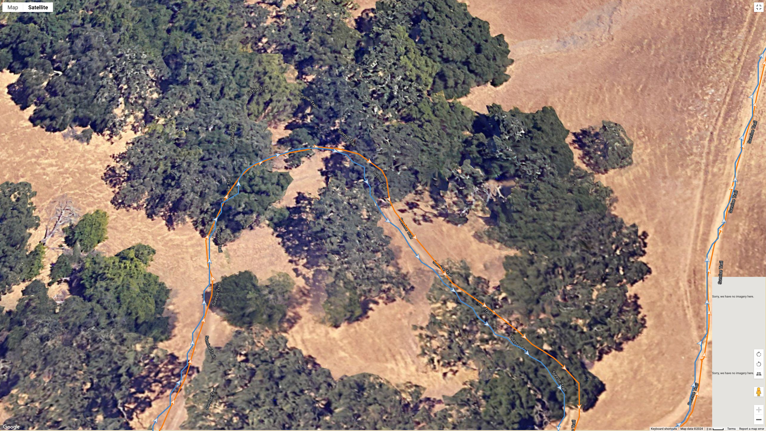 A GPS map showing how the Garmin Forerunner 965 (orange line) and Suunto Race (blue line) compare on a hike with plenty of satellite signal blockage.