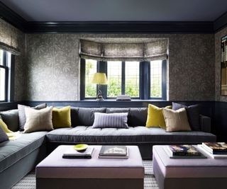 den with dark gray walls and sectional sofa