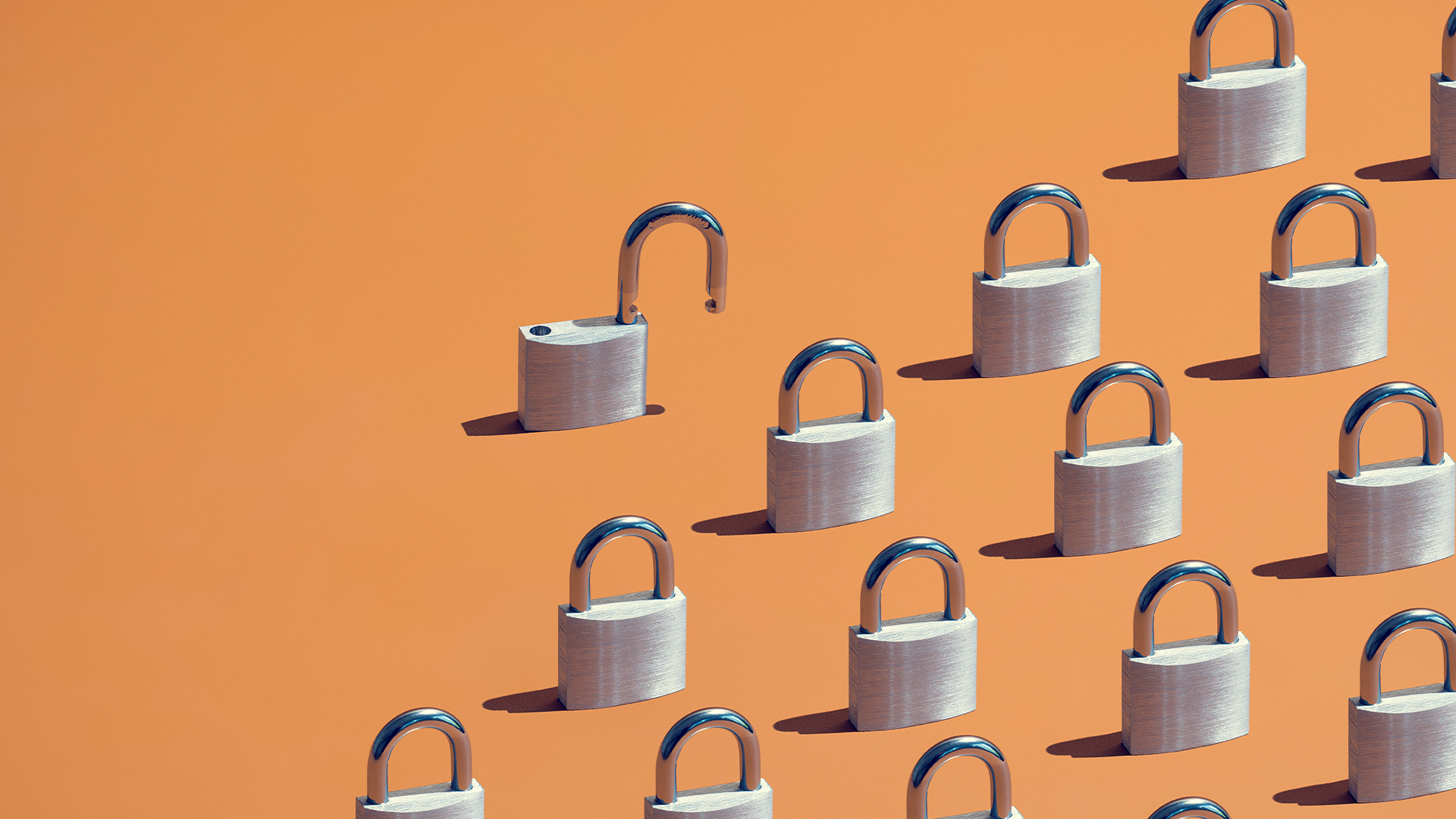 Supply chain security concept image showing 15 locked padlocks with one outlying padlock left unlocked. 