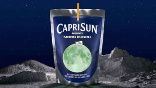 a foil drink bag with a glowing full moon on its label sits on a lunar surface