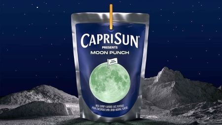 a foil drink bag with a glowing full moon on its label sits on a lunar surface