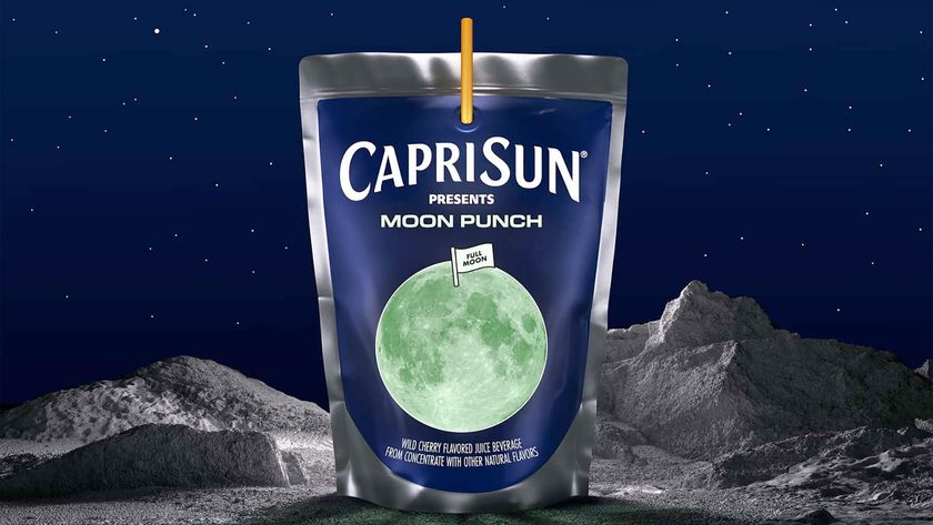 a foil drink bag with a glowing full moon on its label sits on a lunar surface