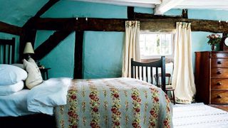 Bedroom with exposed beams in a cottage