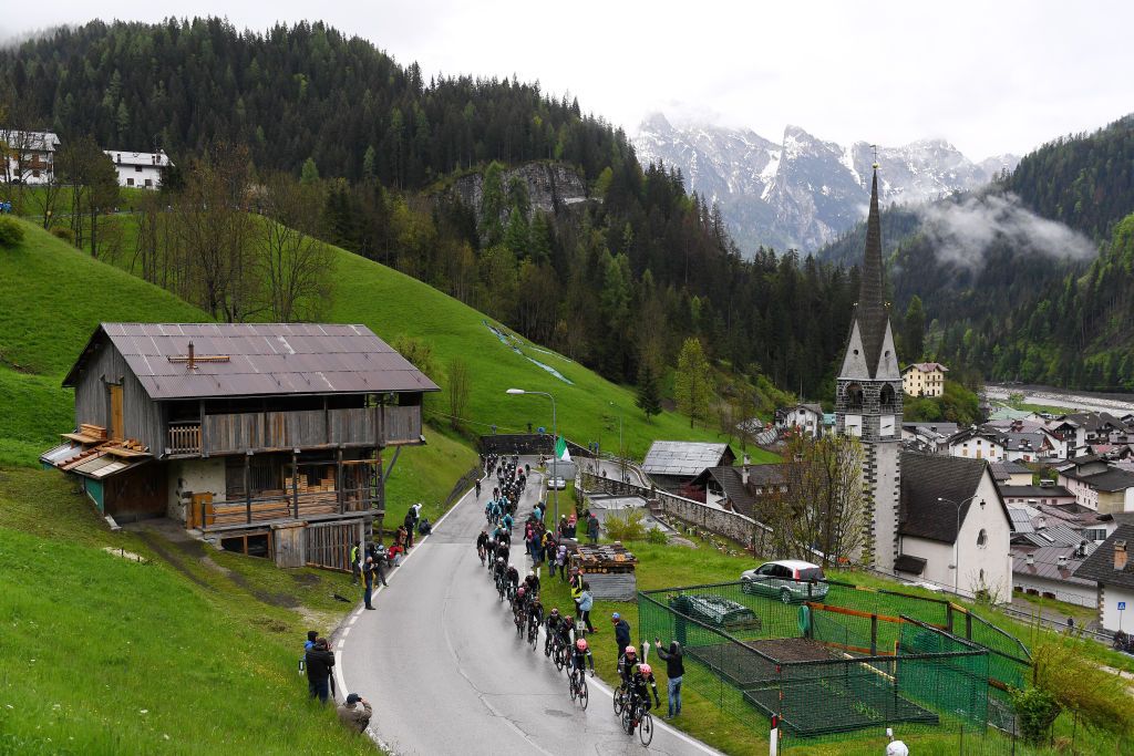 CORTINA DAMPEZZO ITALY MAY 24 Alberto Bettiol of Italy and Team EF Education Nippo Hugh Carthy of United Kingdom and Team EF Education Nippo leads The Peloton the peloton passing through Caprile village 998m mountain landscape during the 104th Giro dItalia 2021 Stage 16 a 153km stage shortened due to bad weather conditions from Sacile to Cortina dAmpezzo 1210m Rain Fog Snow girodiitalia Giro on May 24 2021 in Cortina dAmpezzo Italy Photo by Tim de WaeleGetty Images