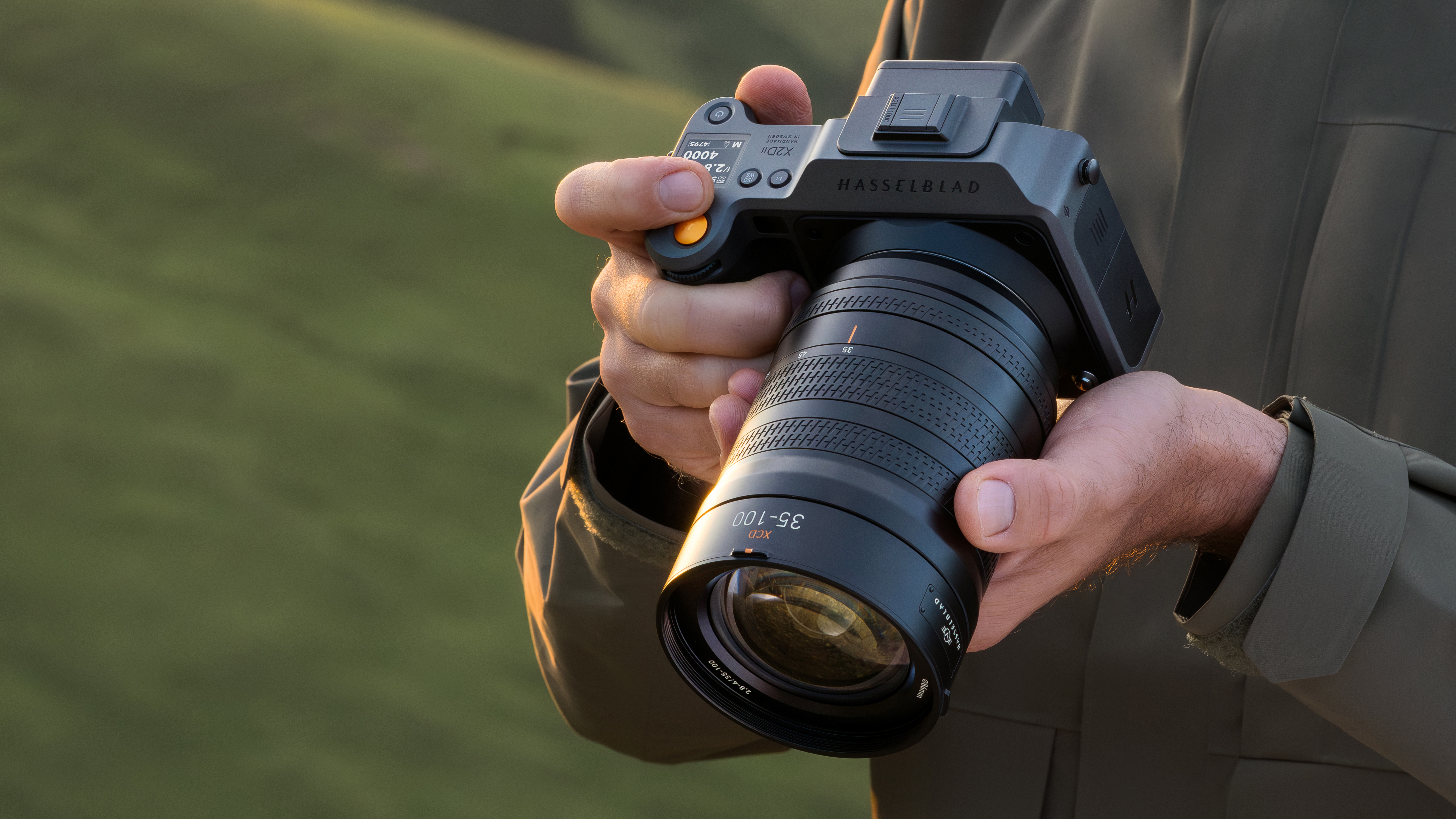 Hasselblad X2D II 100C and Hasselblad XCD 35-100E being used by a photographer outdoors