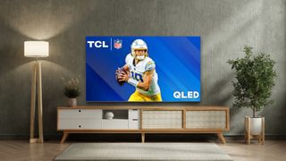 TCL QLED TV on stand in living room