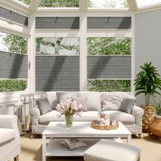 Conservatory with grey blinds and sofas