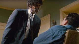 Samuel L Jackson looms over someone sitting in a chair beneath him in Pulp Fiction.