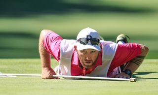 Lexi Thompson's caddie Mark Wallington reads a green at the 2024 KPMG Women's PGA Championship