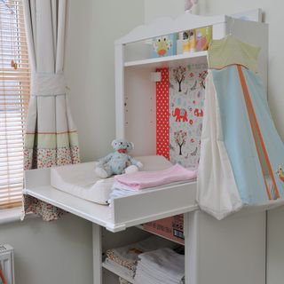 nursery with changing table and toy