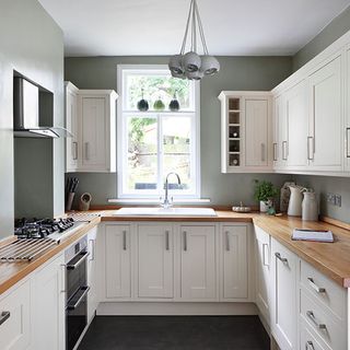 kitchen room with white cabinets and kitchen chimney