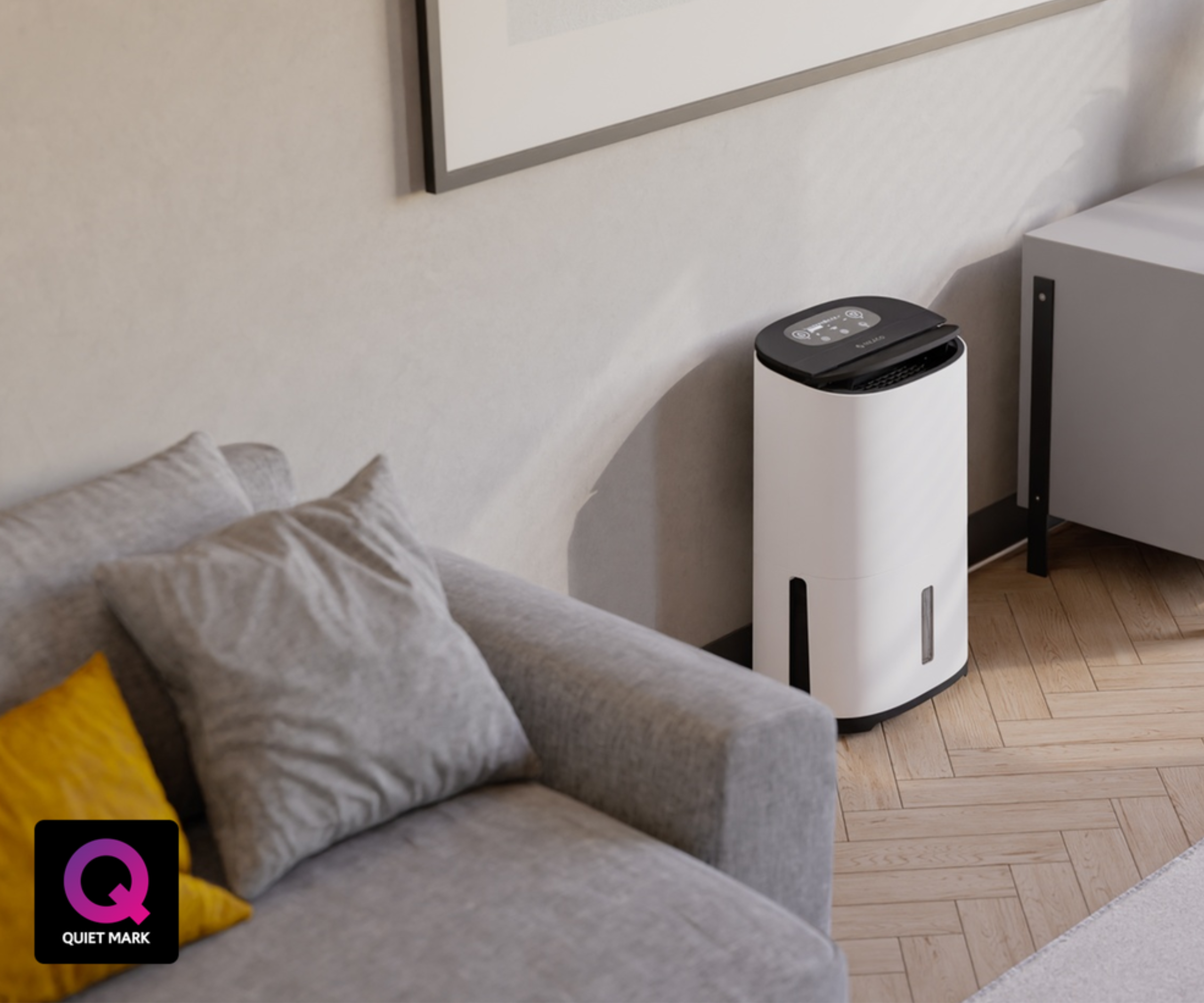 A white portable dehumidifier pushed against a wall between a grey sofa and a white sideboard