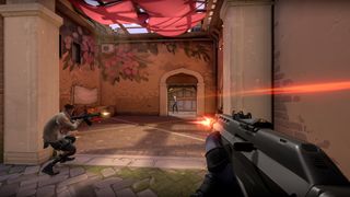 A good of players taking cover and shooting each other on a map in the FPS game Valorant.