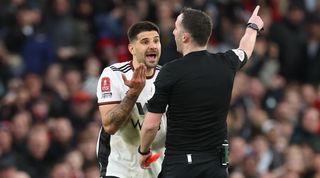 Fulham striker Aleksadar Mitrovic is sent off for pushing referee Chris Kavanagh in his side's FA Cup quarter-final against Manchester United.