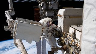 NASA astronaut Andrew Morgan works on the Alpha Magnetic Spectrometer during a spacewalk at the International Space Station.