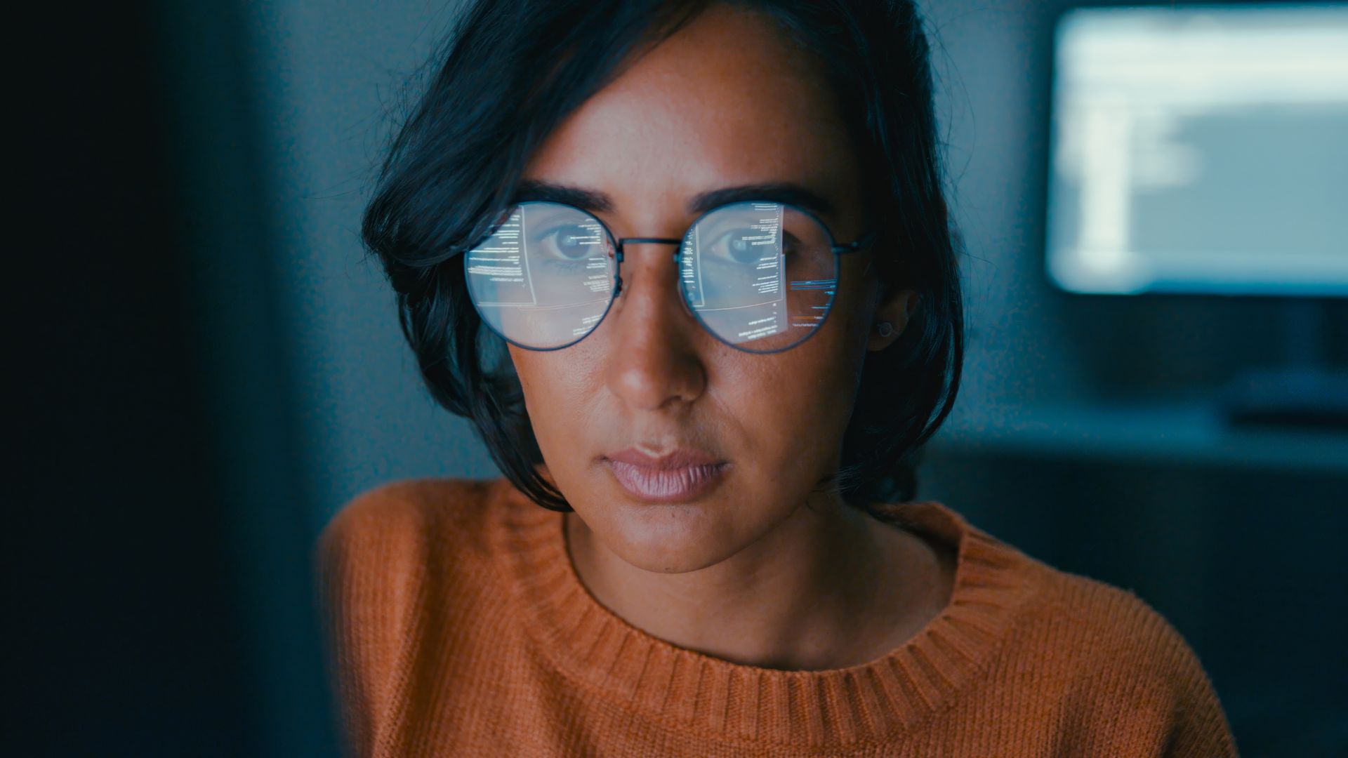 Female computer programmer works on complex software development tasks at her home office late into the night. Software developer, artificial intelligence and programming concept.