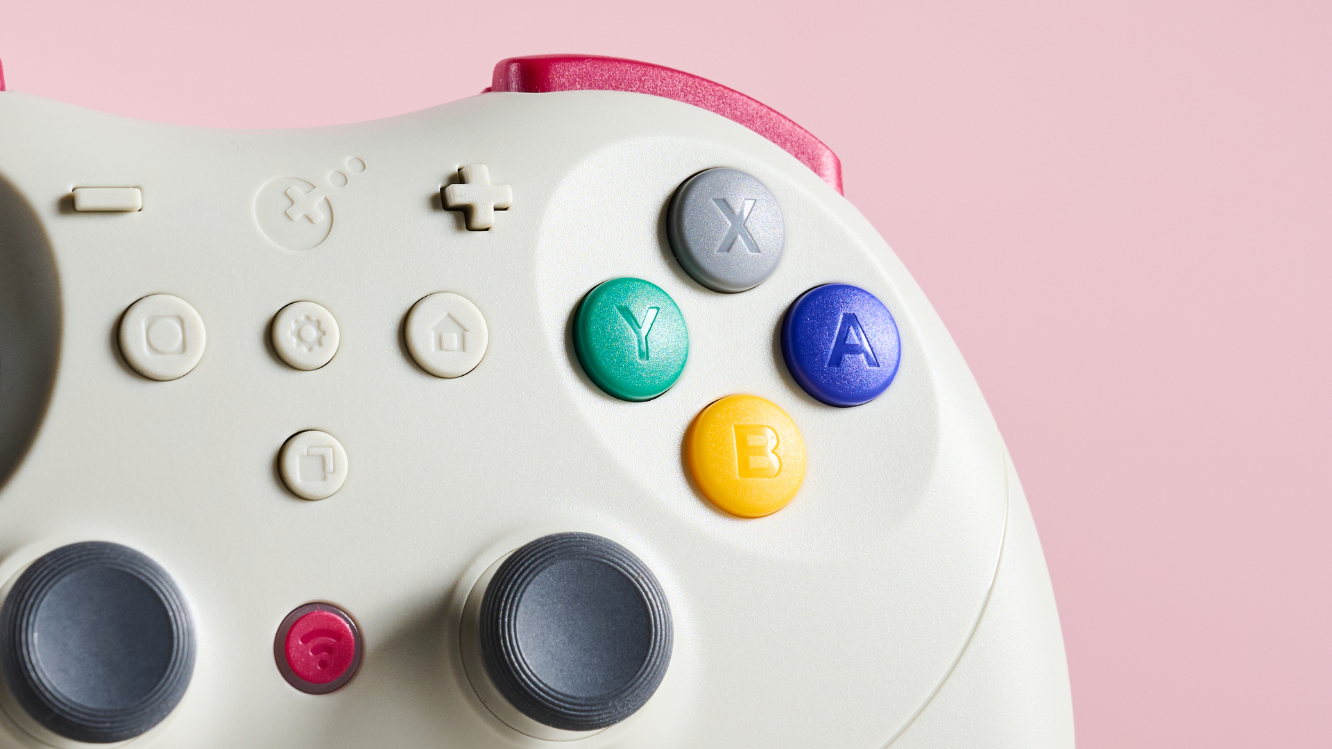 Close-up of face buttons and joysticks on GuliKit Elves 2 Pro on pink background