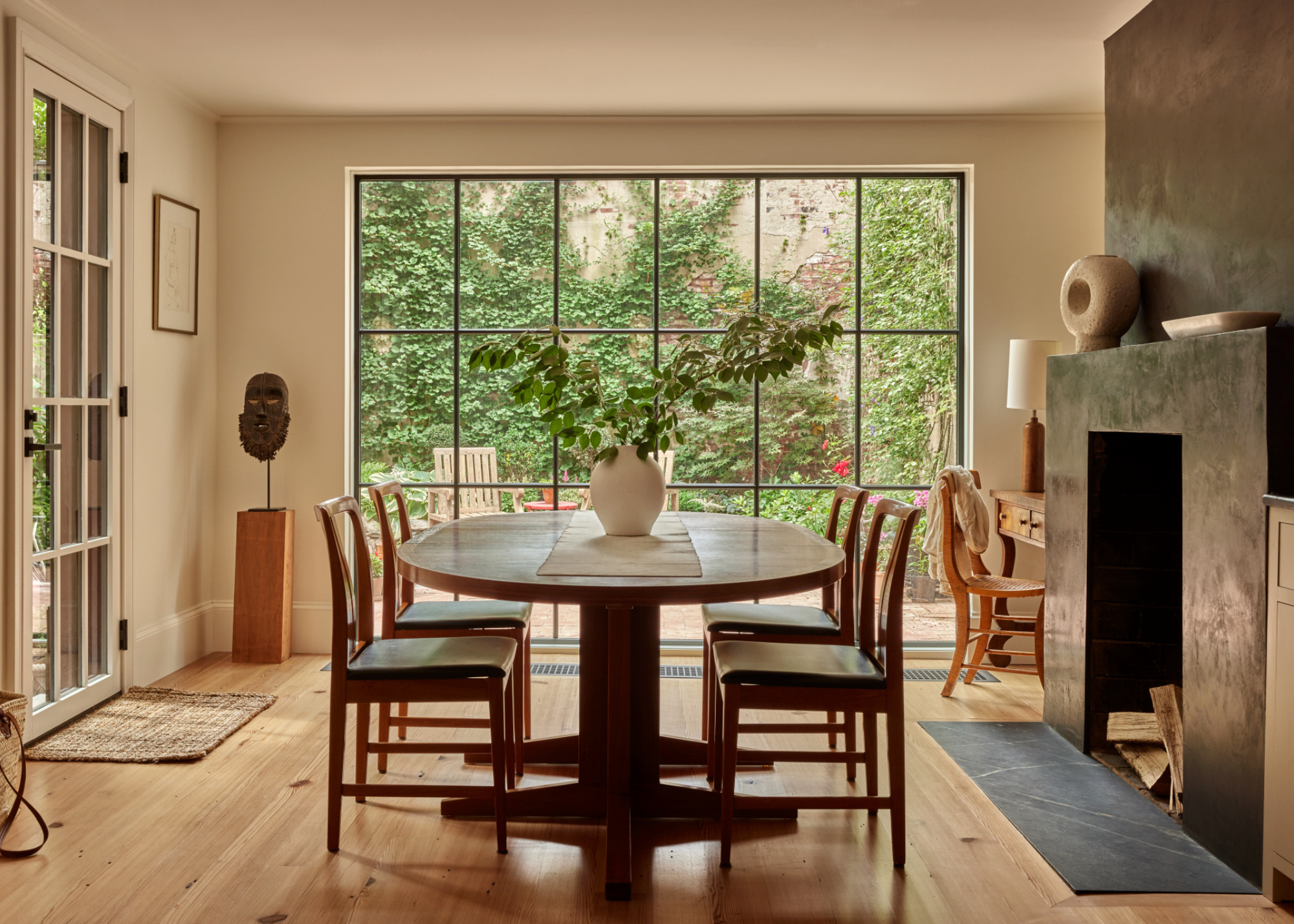 a beautiful wooden floored dining room with a huge fireplace
