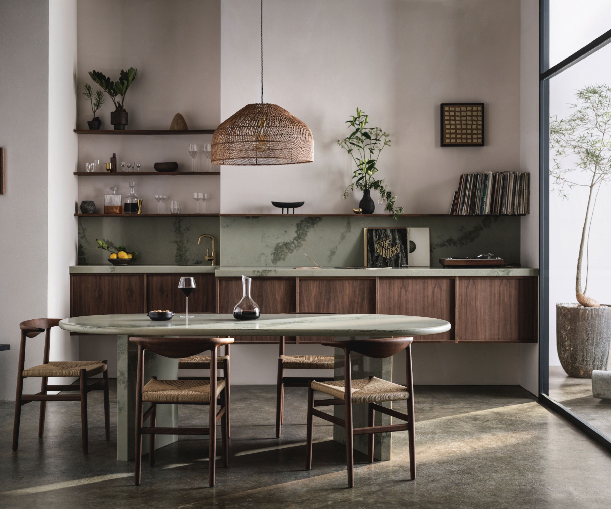 A small kitchen with white walls, dark wood cabinetry, and green stone countertops