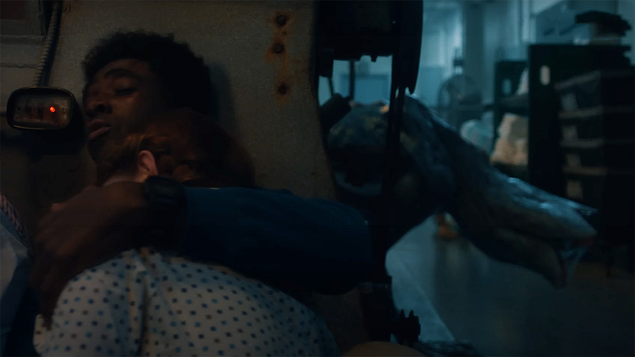 Lucas hiding while holding Max's comatose body as a demodog prowls around in Stranger Things season 5