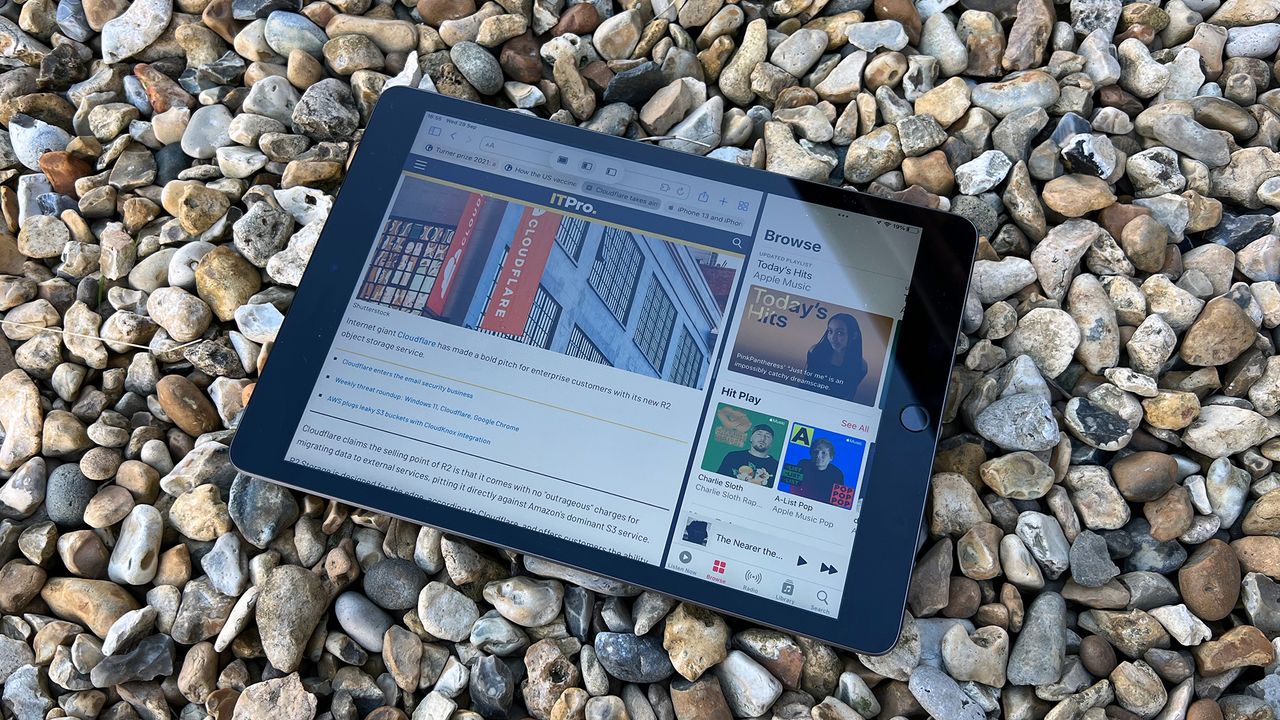 A photograph of the 12.9in 2021 Apple iPad Pro on a bed of stones