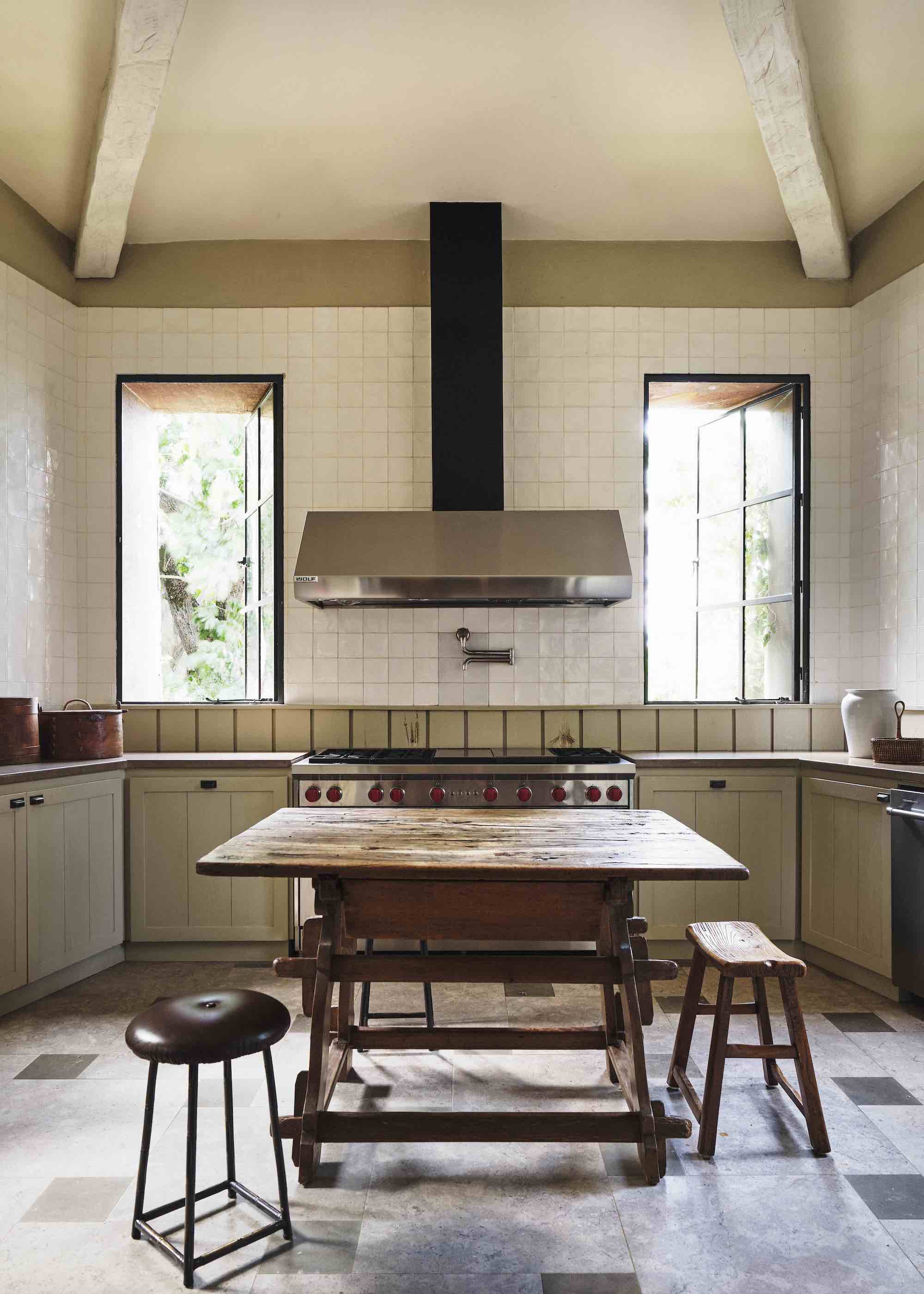 cream kitchen with wood vintage island and stools