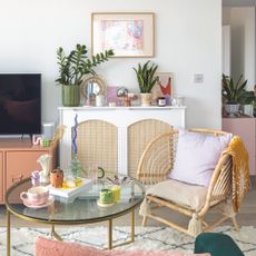 Living room with rattan armchair, rattan radiator cover and coffee table.