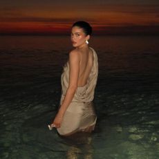 Kylie Jenner wearing a silver dress in the ocean in Turks and Caicos on Spring Break in April 2024