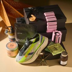 A flat lay shot of the best self care gifts, including Stella McCartney x adidas trainers, Bala bangles, Aery bath salts and more