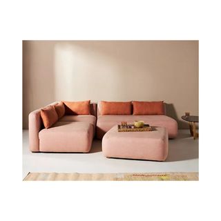 pink sofa with rust pillows