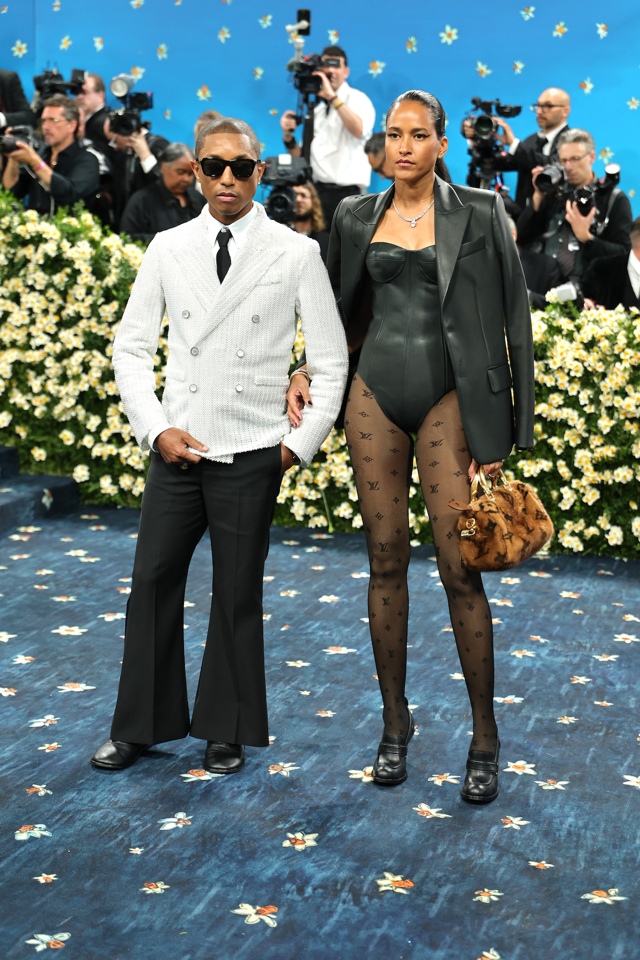 NEW YORK, NEW YORK - MAY 05: (L-R) Pharrell Williams, Met Gala Co-Chair, and Helen Lasichanh attend the 2025 Met Gala Celebrating "Superfine: Tailoring Black Style" at Metropolitan Museum of Art on May 05, 2025 in New York City. (Photo by Dia Dipasupil/Getty Images)