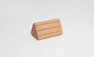a light-weight triangular cork block with carefully formed grooves for easy handling