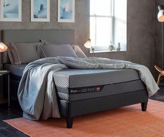 The Layla Hybrid Mattress on a bed against a gray wall.