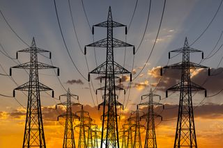 High voltage power line towers at sunset