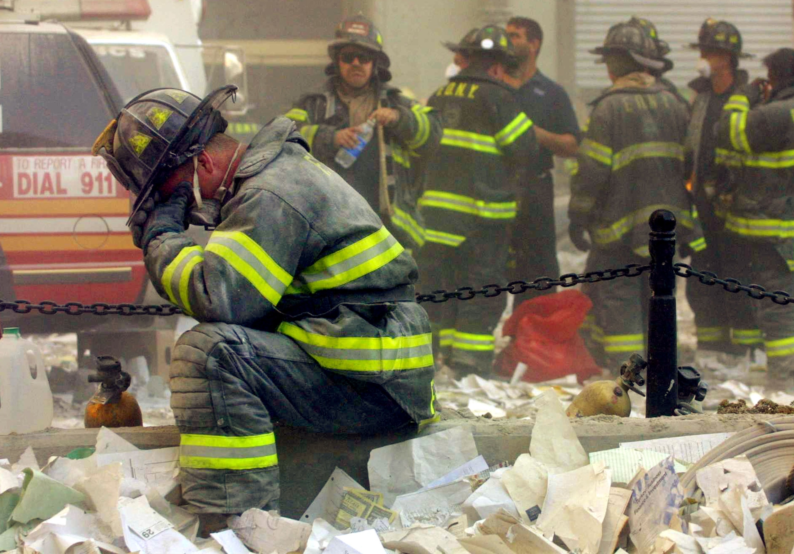 Firefighter Gerard McGibbon, of Engine 283 in Brownsville, Brooklyn, prays after the World Trade Center buildings collapsed September 11, 2001 after two hijacked airplanes slammed into the twin towers in a terrorist attack that killed some 3,000 people. (Photo by Mario Tama/Getty Images)