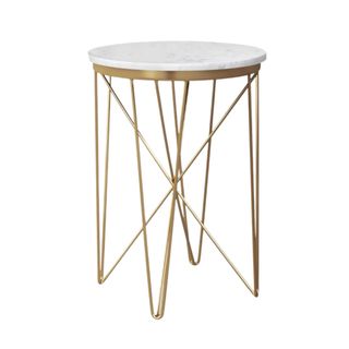 A gold side table with a white marble top