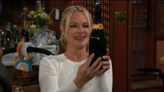 Sharon Case as Sharon holding a champagne bottle in The Young and the Restless