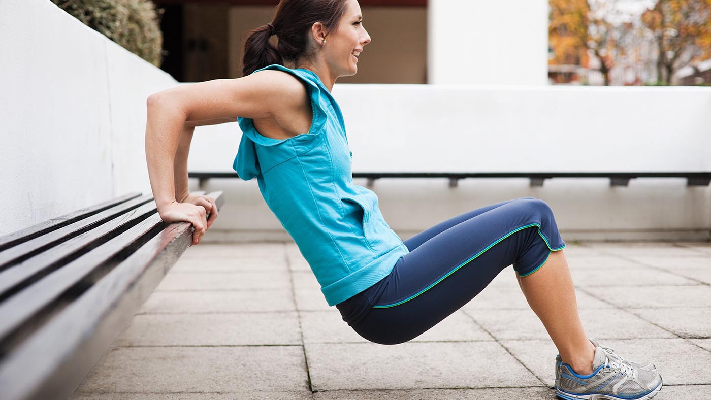 CCA7AE Woman in sportswear performing tricep dips