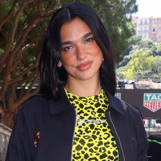 Dua Lipa visited Hyde Park in jean shorts, chunky ankle boots, and the Chanel 25 bag.