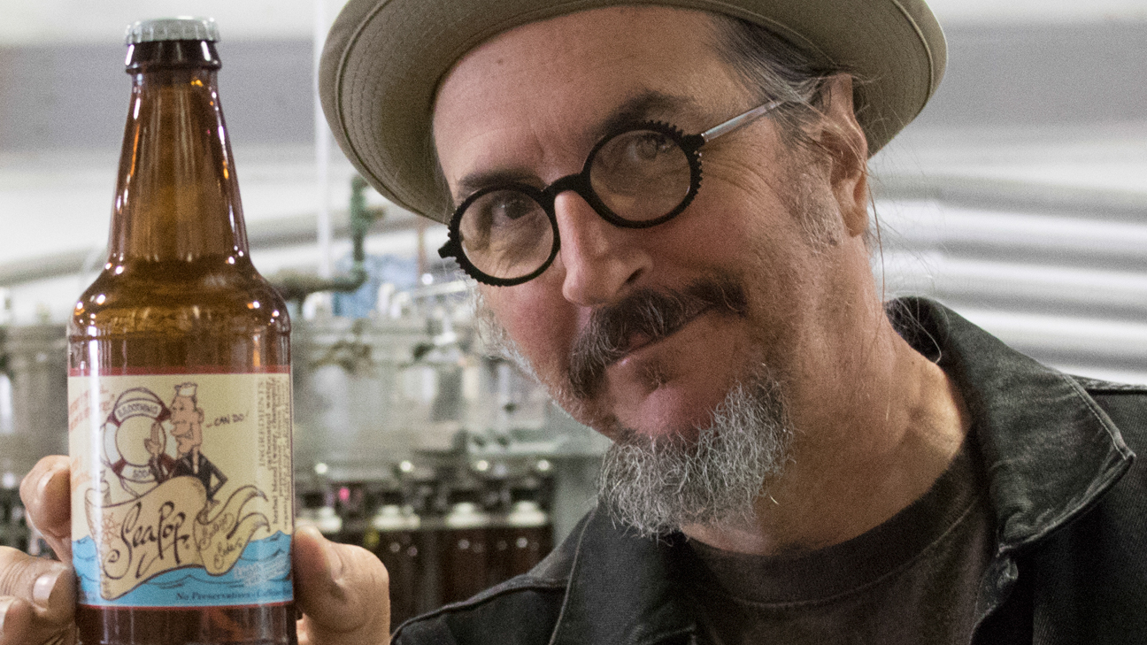 Primus frontman Les Claypool poses with a bottle of his SeaPop soft drink