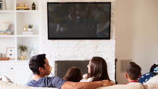 Family watching TV wall mounted