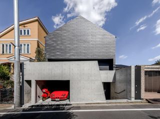 Terada house with a red car parked outside, in Tokyo
