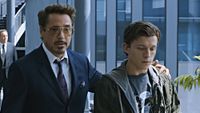 Tony Stark (Downey Jr) wraps his arm around a young Peter Parker, aka Spider-Man (Holland) in Spider-Man: Homecoming. 
