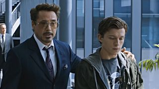 Tony Stark (Downey Jr) wraps his arm around a young Peter Parker, aka Spider-Man (Holland) in Spider-Man: Homecoming. 