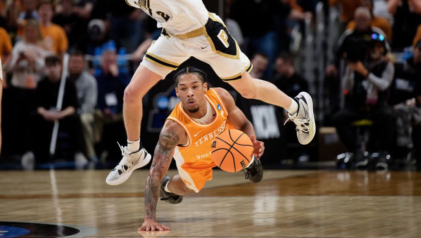 Fletcher Loyer (cropped out of the shot) fouls Zakai Zeigler while battling for control of a loose ball during the Elite Eight round of the 2024 NCAA Men&#039;s Basketball Tournament in March 2024