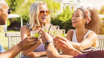 Happy people drinking in the sunshine